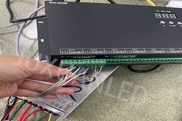 An engineer demonstrating how to connect LED light wires
